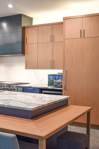 Interior design kitchen with light wood and blue cabinets. Designed by interior designer Erica LeMaster Sargent. 