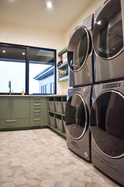 Interior design of laundry rooms with green cabinets. Designed by interior designer Erica LeMaster Sargent. 