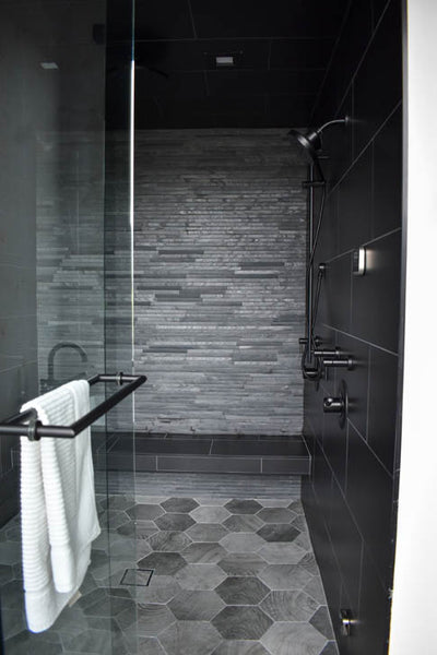 Interior design of dark master bath shower. Black and grey tile and fixtures. Designed by interior designer Erica LeMaster Sargent. 