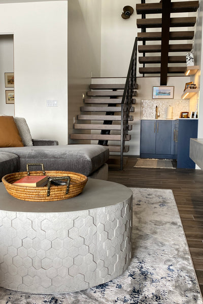 Interior design of living room with floating staircase. Designed by interior designer Erica LeMaster Sargent. 