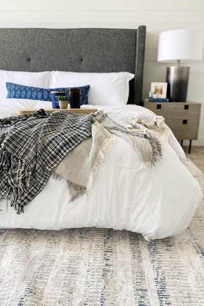 Interior design bedroom with white bed and grey accents. Designed by interior designer Erica LeMaster Sargent. 