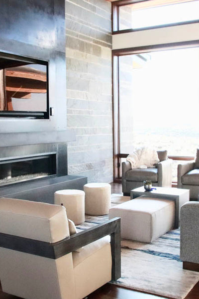 Interior design of living area with custom fireplace and floating wood shelves. Designed by interior designer Erica LeMaster Sargent. 