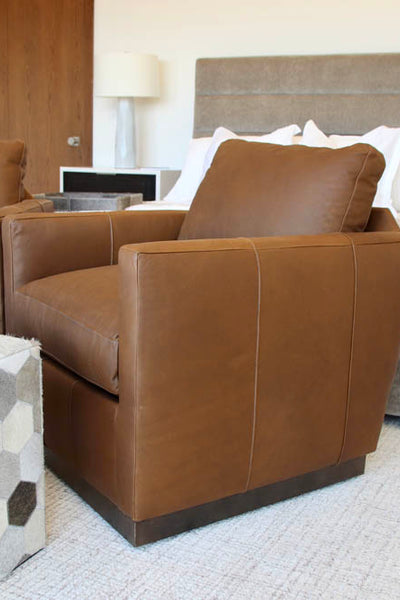 Interior design of mountain styled master bedroom with leather chairs at foot of bed. Designed by interior designer Erica LeMaster Sargent. 