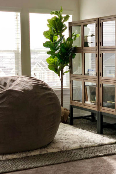 Interior design of room with large love sac and bookcase. Designed by interior designer Erica LeMaster Sargent. 