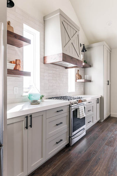 Interior design of kitchen with custom farmhouse styled range hood. Designed by interior designer Erica LeMaster Sargent. 