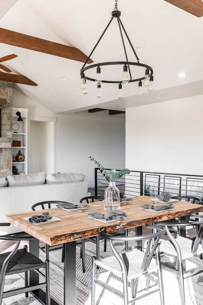 Interior design of kitchen dining area with wagon wheel Edison bulb lighting fixture. Designed by interior designer Erica LeMaster Sargent. 