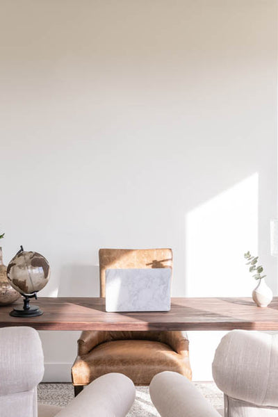 Interior design of office with natural wood desk. Designed by interior designer Erica LeMaster Sargent.