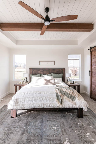 Interior design of guest bedroom with beautiful wood ceiling beam and fan. Designed by interior designer Erica LeMaster Sargent. 