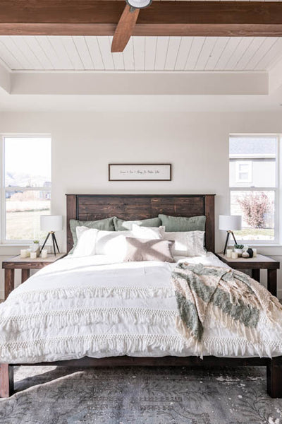 Interior design of bedroom with barn door and wood ceiling beams. Designed by interior designer Erica LeMaster Sargent. 