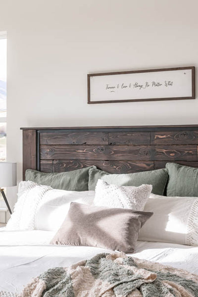 Interior design of transitional styled of bedroom with wood bed frame. Designed by interior designer Erica LeMaster Sargent. 