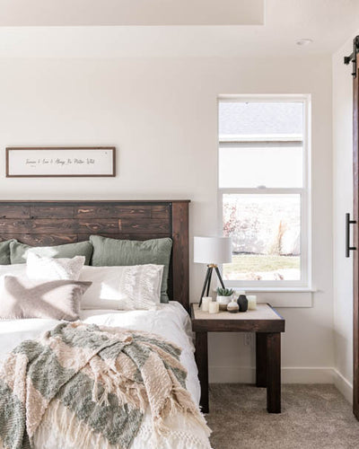 Interior design of guest bedroom with natural wood headboard on bed. Designed by interior designer Erica LeMaster Sargent. 