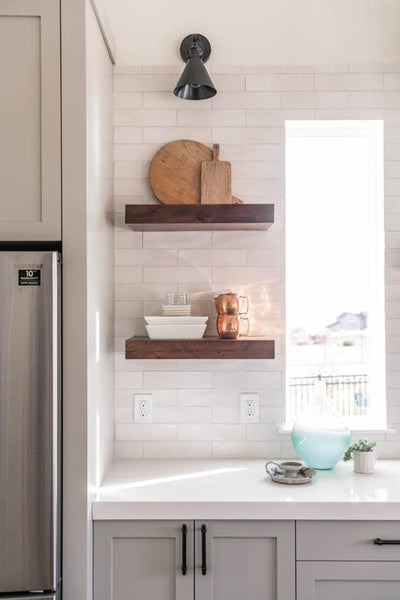 Interior design of kitchen with natural wood floating shelves. Designed by interior designer Erica LeMaster Sargent. 