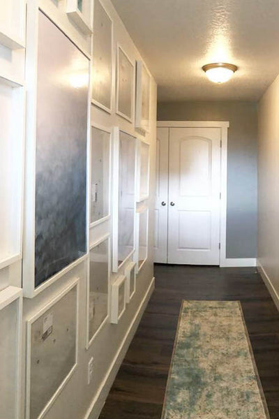 Interior design of home hallway with pictures. Designed by interior designer Erica LeMaster Sargent. 