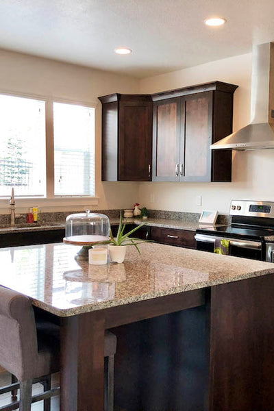 Interior design of kitchen with dark wood counter tops and stainless steal appliances. Designed by interior designer Erica LeMaster Sargent. 