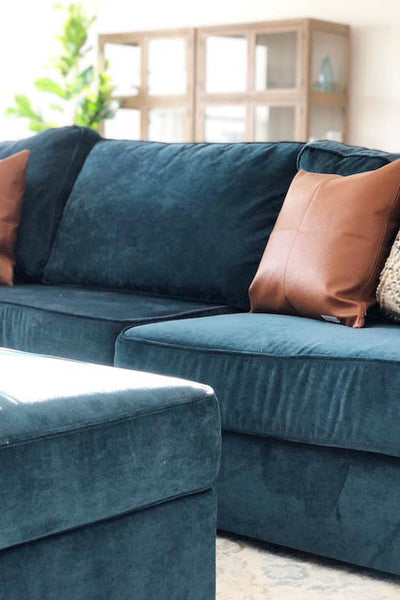 Interior design of living area with teal blue velvet sofa. Designed by interior designer Erica LeMaster Sargent. 