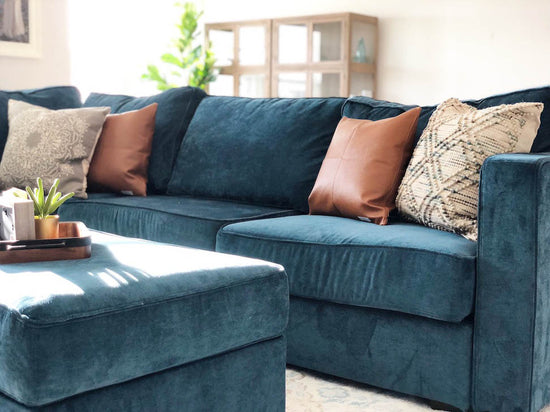 Interior design of living area with teal blue velvet sofa. Designed by interior designer Erica LeMaster Sargent. 