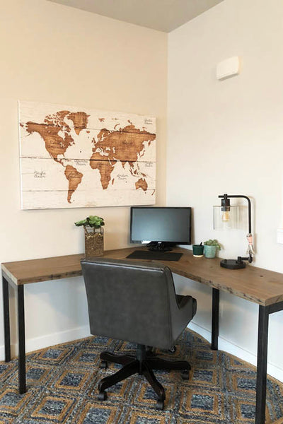 Interior design of home office with wood desk and map on wall. Designed by interior designer Erica LeMaster Sargent. 