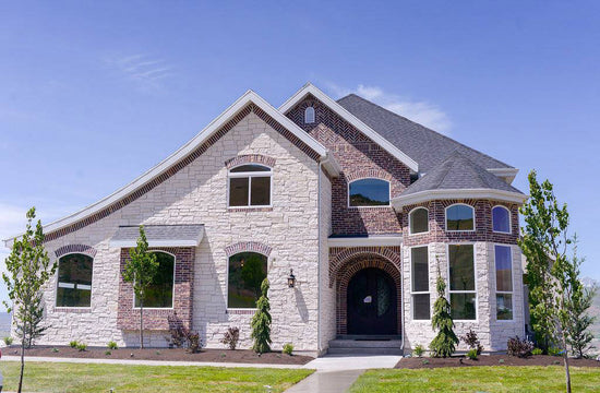 Exterior design of Texas colonial styled home with red brick and cream stone. Designed by interior designer Erica LeMaster Sargent. 